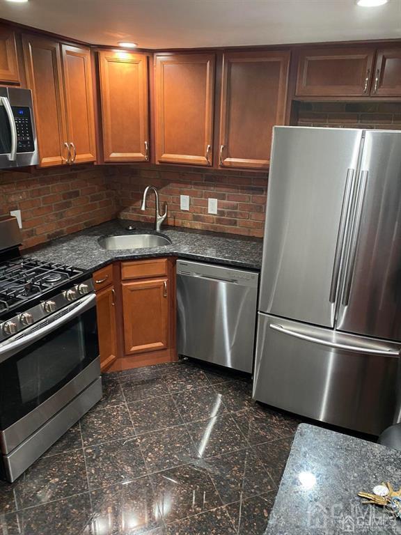 16 Jaques Street, Unit 22 Elizabeth, NJ 07201 - Photo 3 of 27 a kitchen with granite countertop stainless steel appliances and wooden cabinets