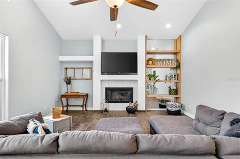 a living room with furniture and a fireplace