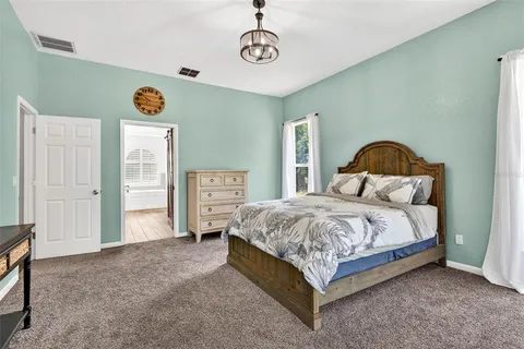 a spacious bedroom with a bed and window