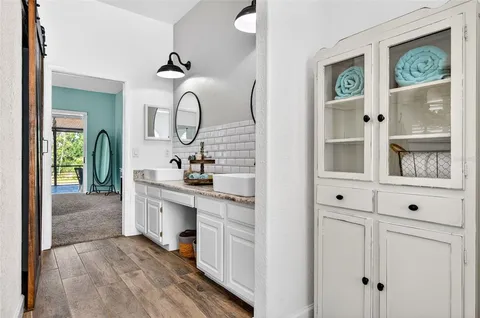a bathroom with double vanity sink and a mirror
