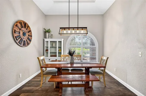 a dining room with furniture and window