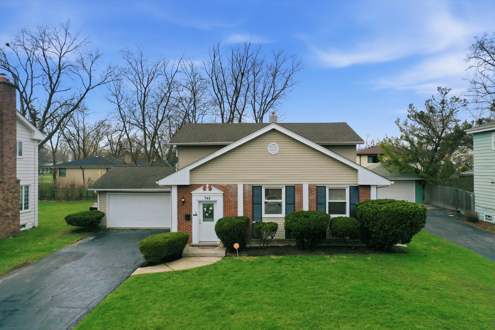 748 Ash Street Flossmoor, IL 60422 - Photo 1 of 21 a front view of a house with a yard and garage