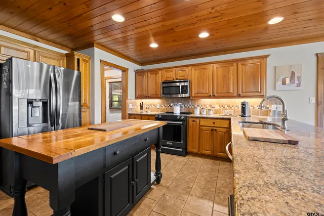 a kitchen with a refrigerator a stove a sink and a microwave