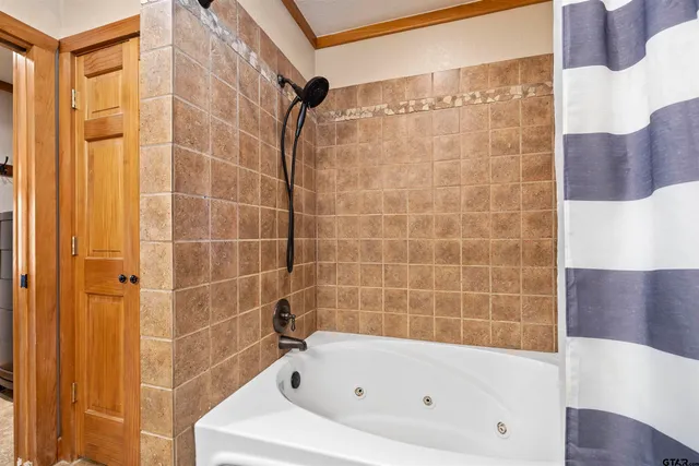 a bathroom with a bathtub and a shower