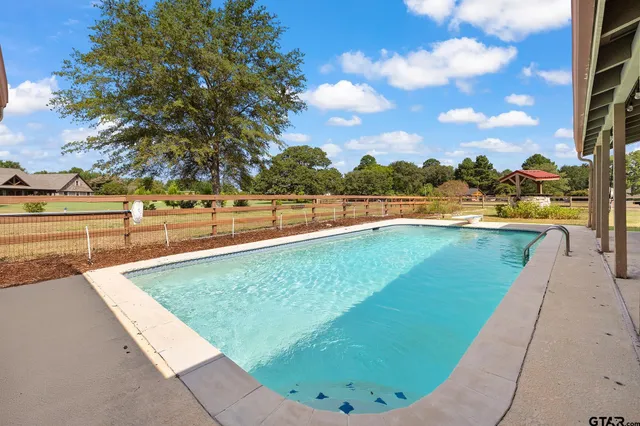 a view of a swimming pool with an outdoor seating