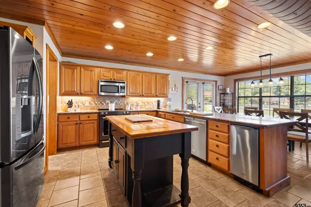 a kitchen with a stove sink and refrigerator