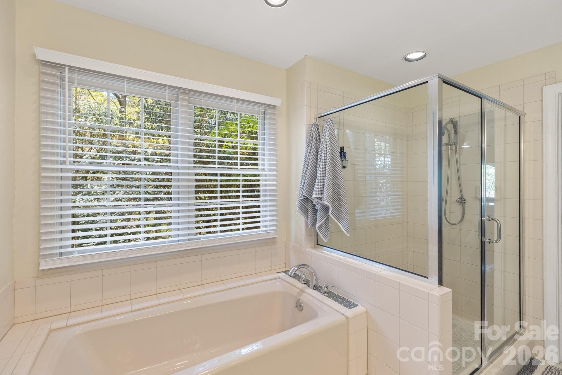 940 Winding Creek Road Sapphire, NC 28774 - Photo 22 of 44 a bathroom with a bathtub and a shower