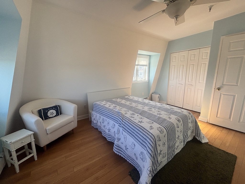 132 Bay Street, Unit 8 Hull, MA 02045 - Photo 5 of 8 a bedroom with a bed and a couch