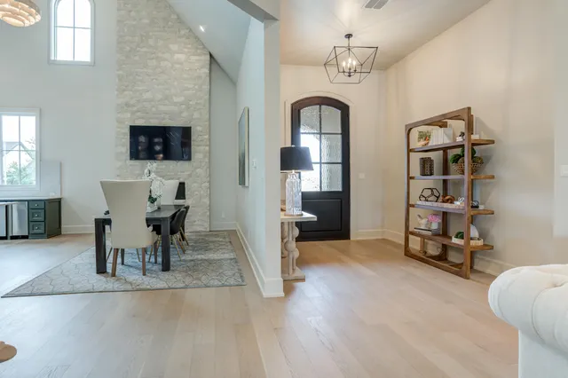 a living room with furniture a rug and a flat screen tv