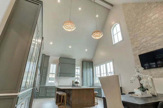 a kitchen with a sink cabinets and wooden floor