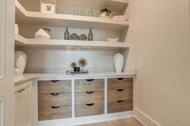 a kitchen with cabinets and a refrigerator
