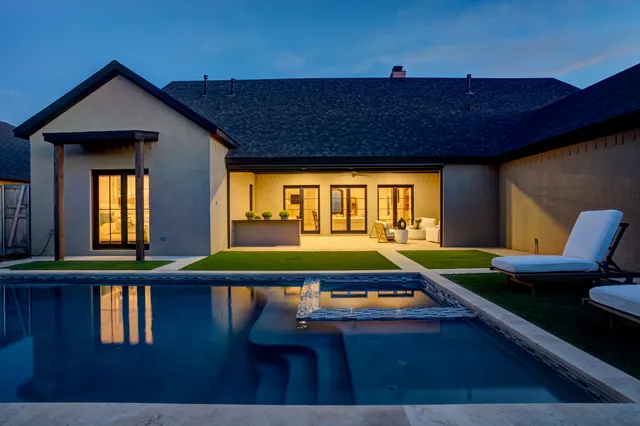 a room with pool table and windows