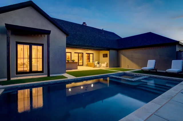 a room with pool table and windows