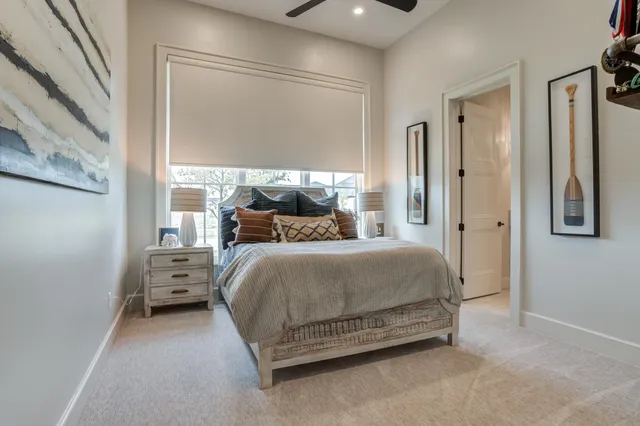 a living room with furniture and floor to ceiling window