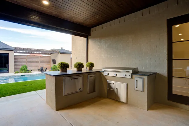 a view of a house with swimming pool and a yard