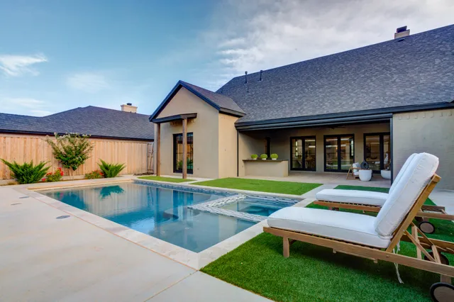 a view of a livingroom with couch and a potted plant