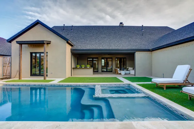 a view of an house with backyard porch and furniture