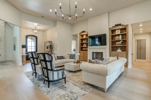 a living room with furniture fireplace and flat screen tv