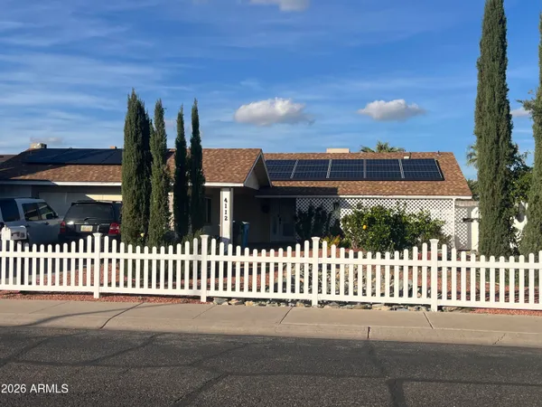 a front view of a house with a fence