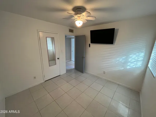 a view of a livingroom with an empty space and a ceiling fan