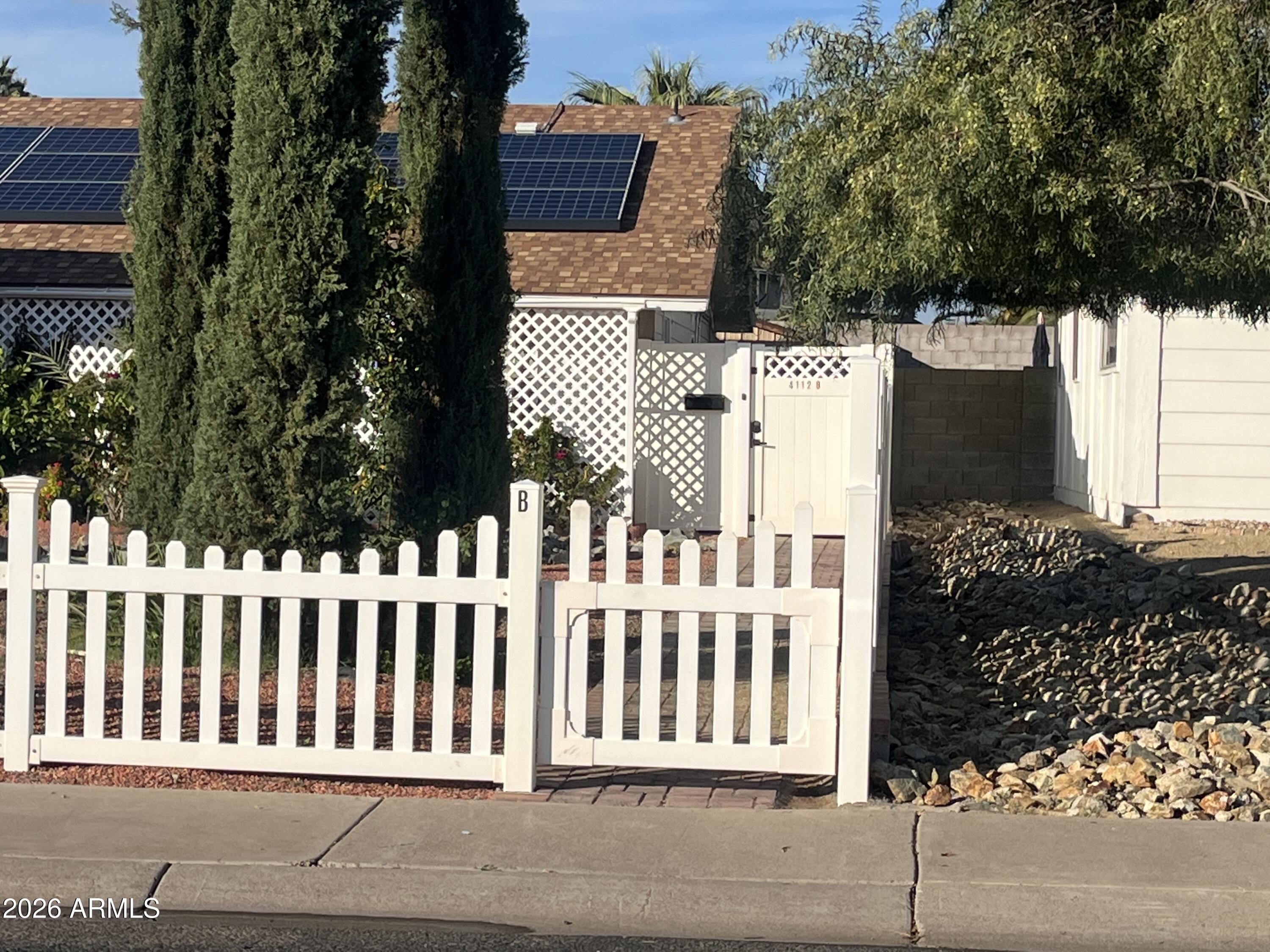 4112 West Hearn Road Phoenix, AZ 85053 - Photo 2 of 13 a view of a house with a small yard and wooden fence