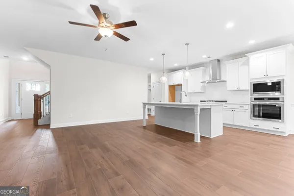 a kitchen with stainless steel appliances a cabinets and a stove top oven