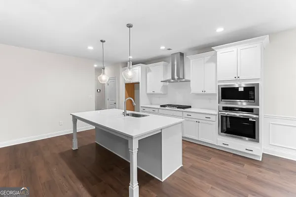 a stove top oven sitting inside of a kitchen