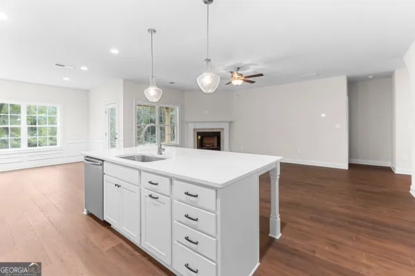 a kitchen with a sink stainless steel appliances and white cabinets