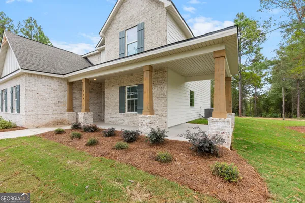 a backyard of a house with table and chairs