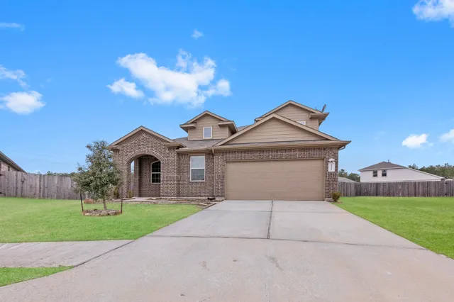 a front view of a house with a yard and garage
