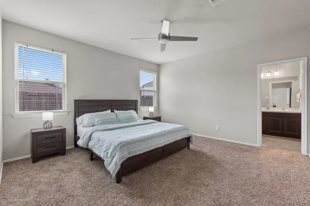 a spacious bedroom with a bed and a table in it
