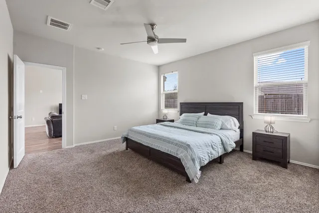 a bedroom with a bed and a chandelier