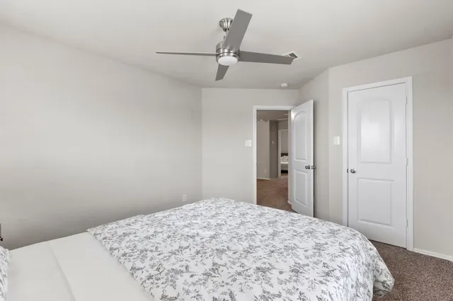 a bedroom with a bed and window