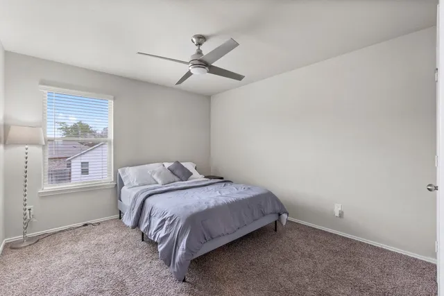 a bedroom with a bed and a lamp