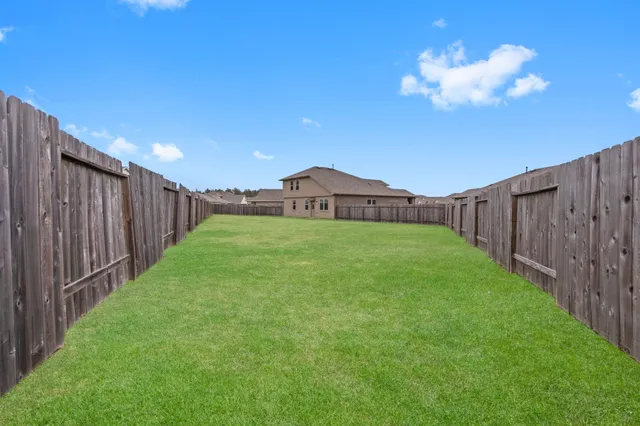 a view of a house with a yard and a garden