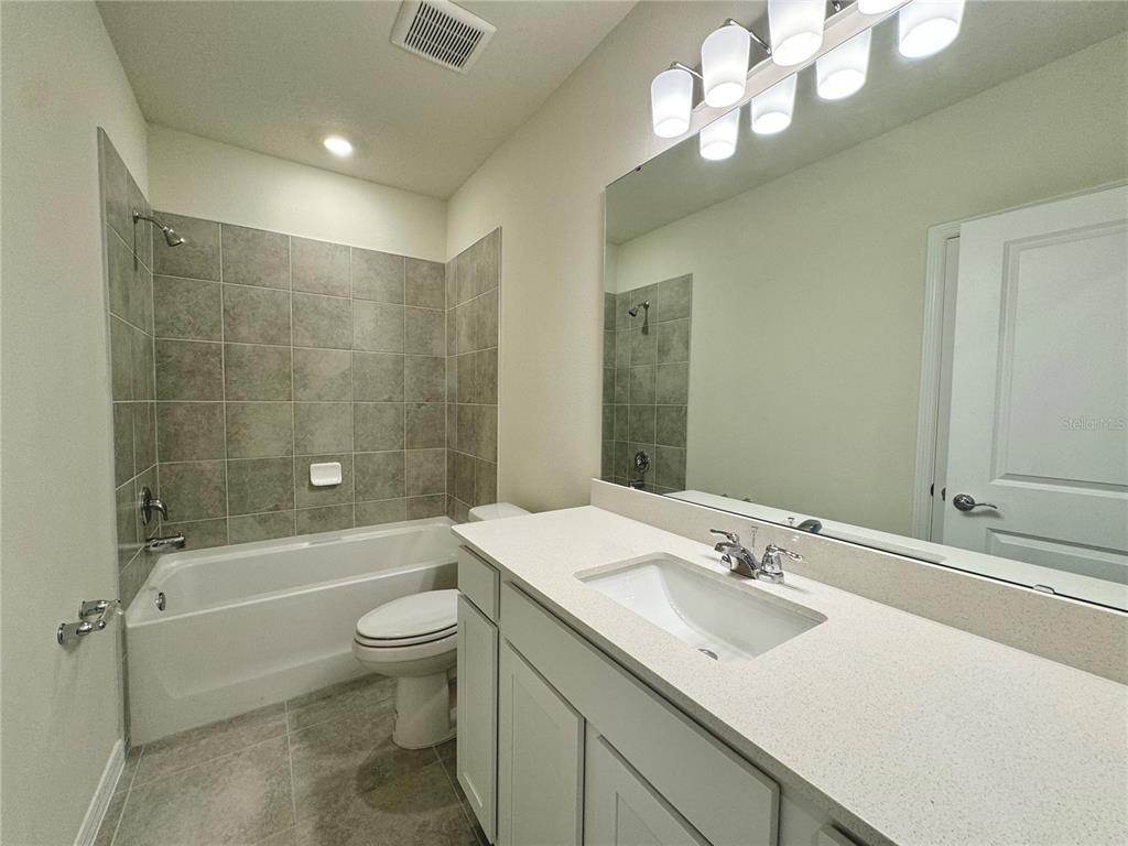3703 Haddon Avenue Davenport, FL 33837 - Photo 19 of 23 a bathroom with a sink a toilet and shower