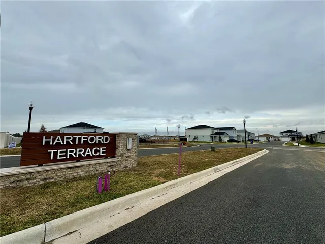 a view of a street with a cars parked on the road