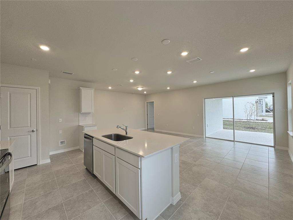 3703 Haddon Avenue Davenport, FL 33837 - Photo 7 of 23 a kitchen that has a sink and a stove
