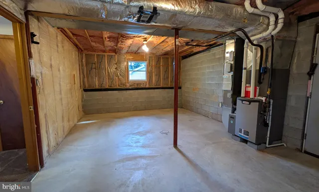 a view of empty room with wooden walls