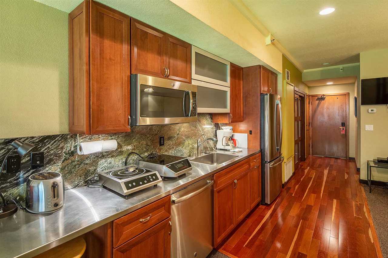 a kitchen with stainless steel appliances a sink dishwasher stove refrigerator and microwave