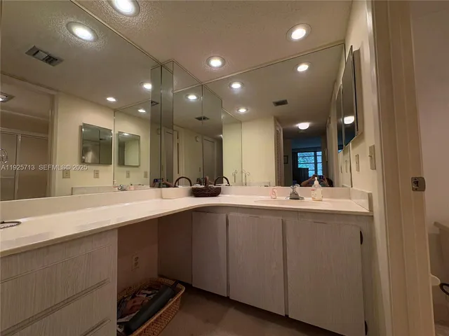 a large kitchen with lots of counter space sink and a refrigerator