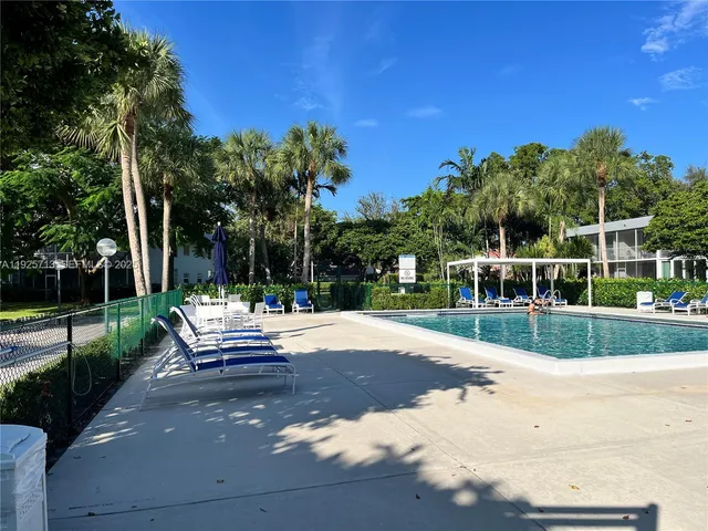 a view of a bench in a yard with potted plants
