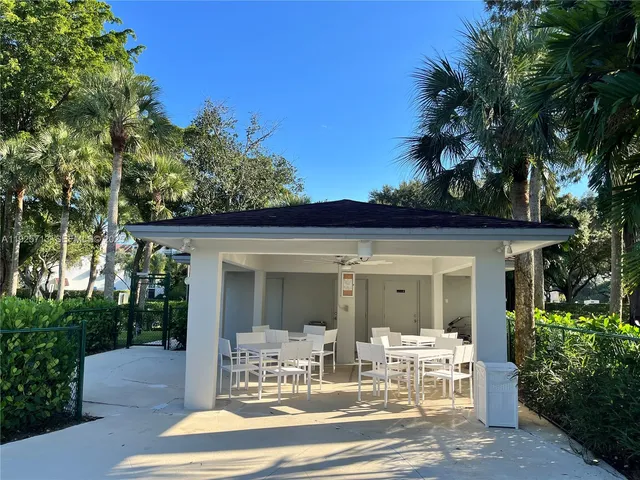 a view of a patio with table and chairs and potted plants