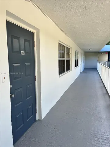 a view of hallway and livingroom with furniture