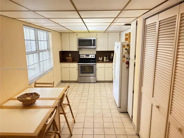 a kitchen with stainless steel appliances a refrigerator and a stove top oven