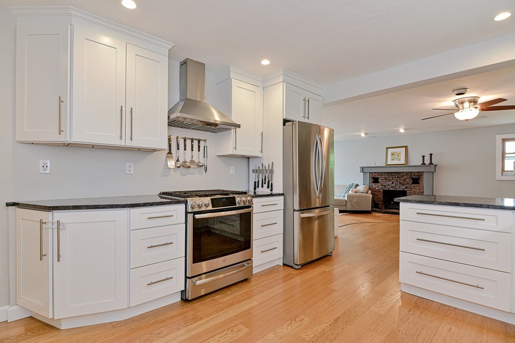 211 Beacon Street Framingham, MA 01701 - Photo 14 of 42 a kitchen with stainless steel appliances granite countertop a stove a refrigerator and a sink
