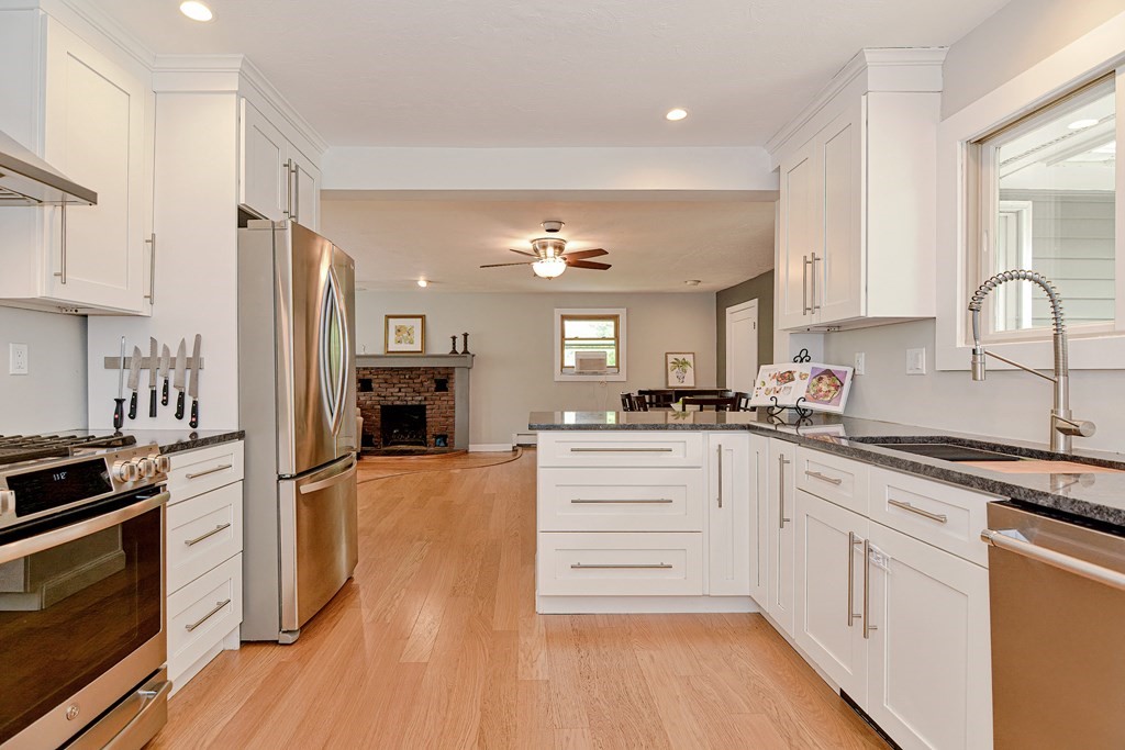 211 Beacon Street Framingham, MA 01701 - Photo 17 of 42 a kitchen with a refrigerator and a stove top oven