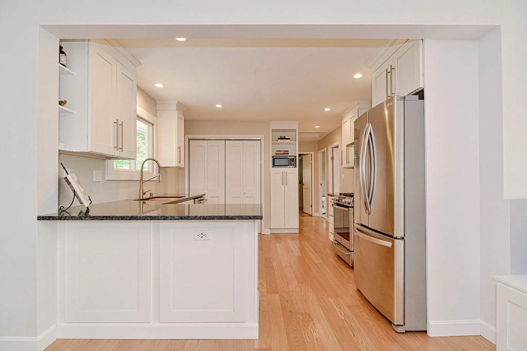 211 Beacon Street Framingham, MA 01701 - Photo 18 of 42 a kitchen with stainless steel appliances granite countertop a refrigerator a sink and a stove