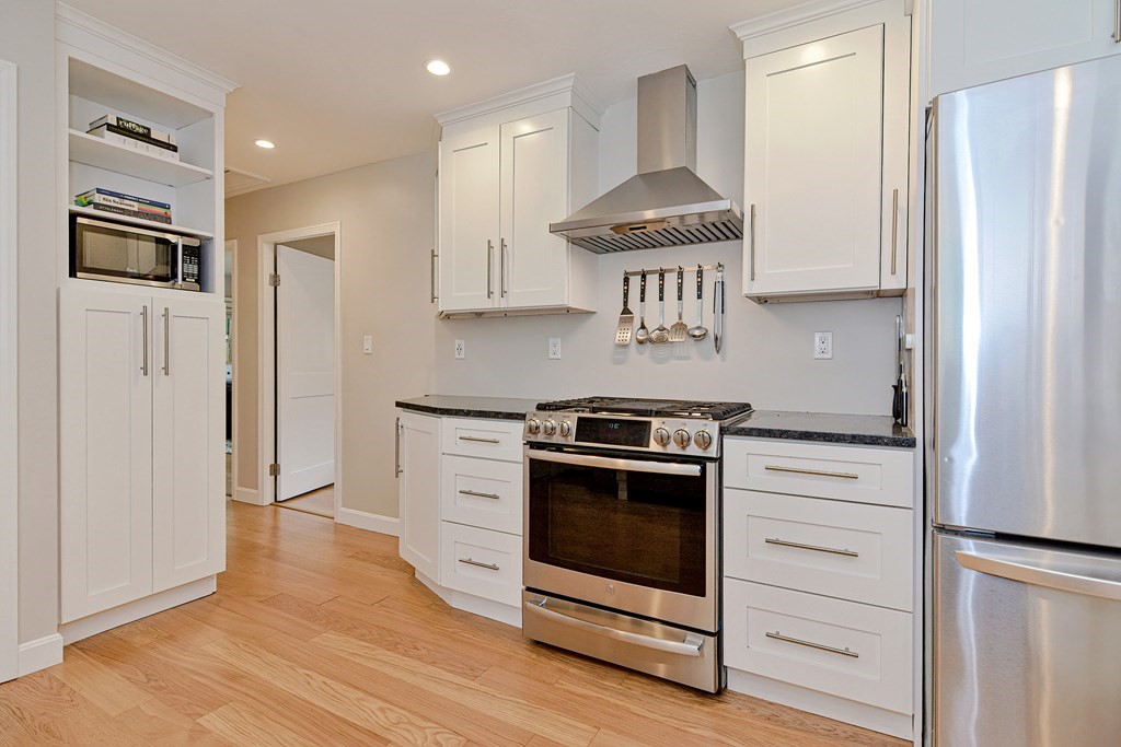 211 Beacon Street Framingham, MA 01701 - Photo 20 of 42 a kitchen with stainless steel appliances a refrigerator stove and sink