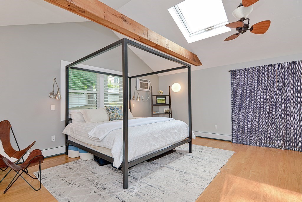 211 Beacon Street Framingham, MA 01701 - Photo 29 of 42 a bed sitting in a bedroom next to a window